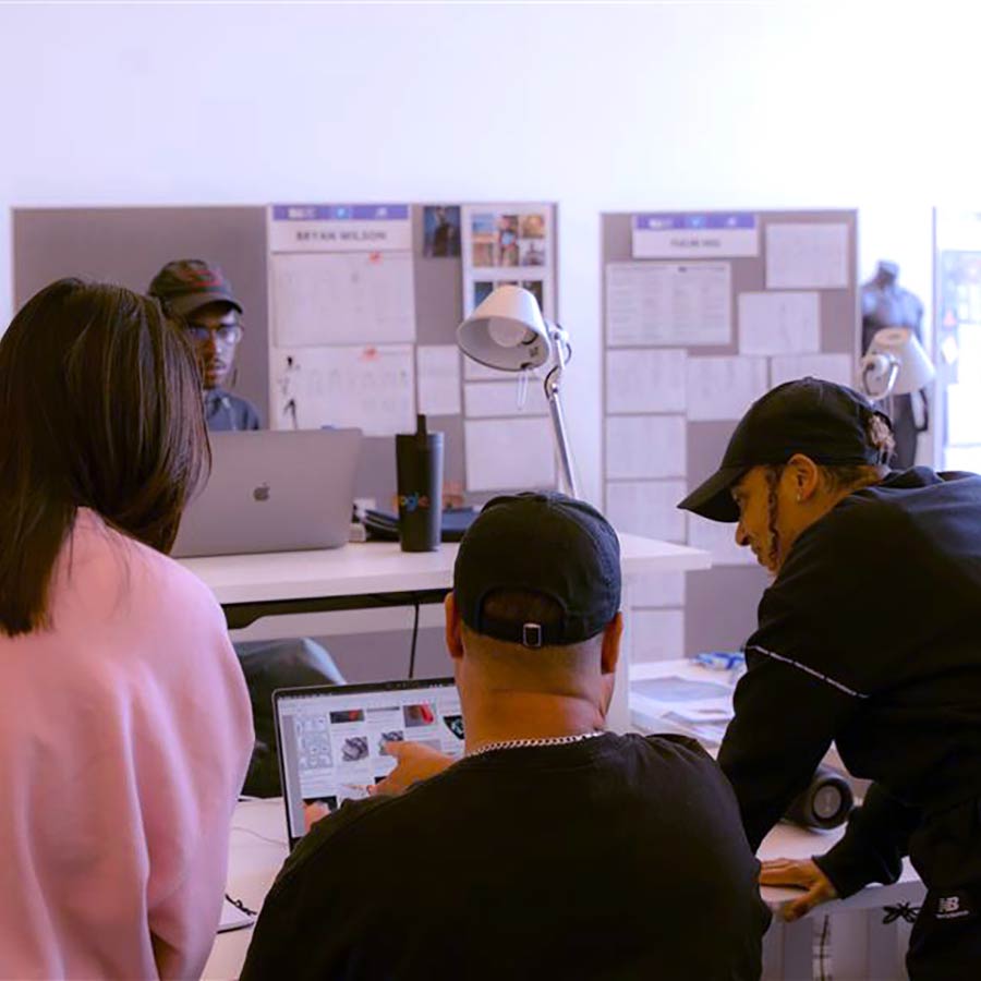 students looking at a computer monitor